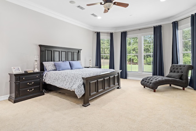 carpeted bedroom featuring ceiling fan and crown molding