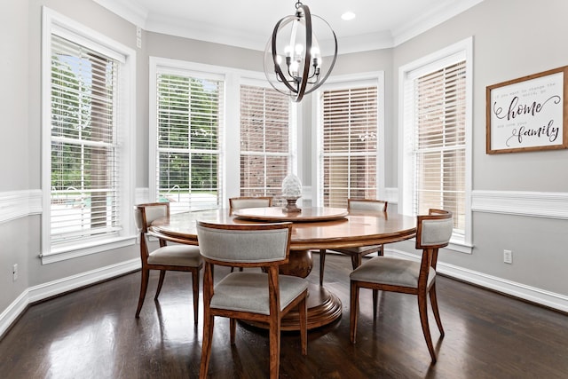 dining area with a notable chandelier, dark hardwood / wood-style flooring, and ornamental molding