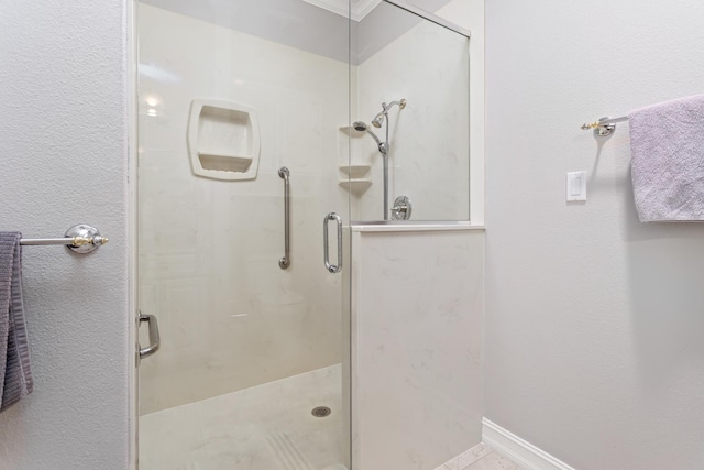 bathroom with tile patterned floors and a shower with door