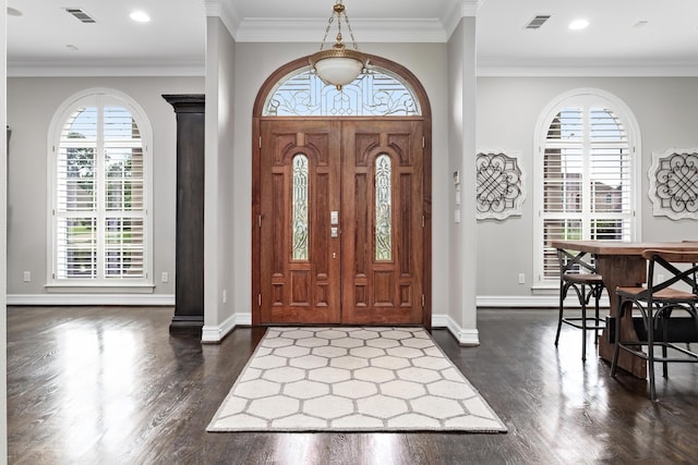 foyer featuring dark hardwood / wood-style floors and crown molding