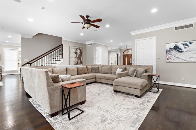 living room with hardwood / wood-style floors, ceiling fan, and crown molding