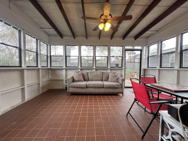 unfurnished sunroom featuring ceiling fan and beam ceiling