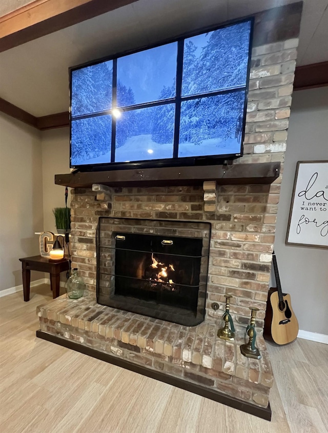 room details with a fireplace, hardwood / wood-style floors, and ornamental molding