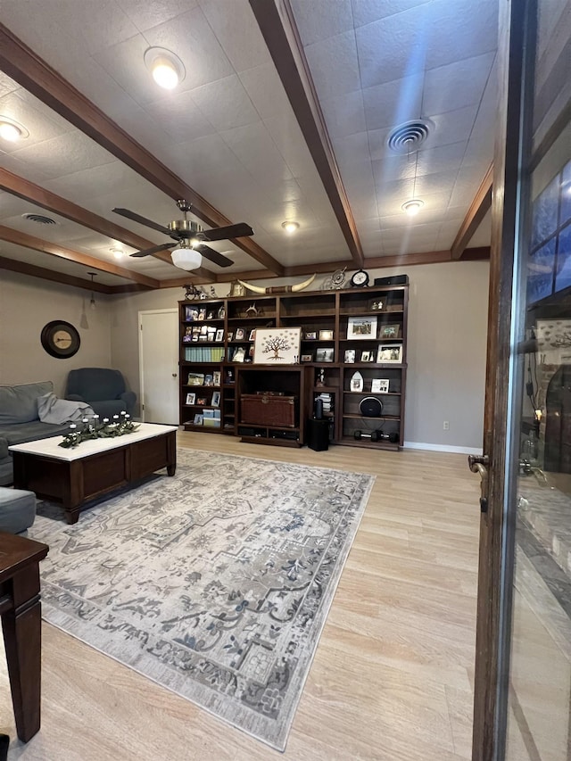 living room featuring beam ceiling, ceiling fan, and light hardwood / wood-style floors