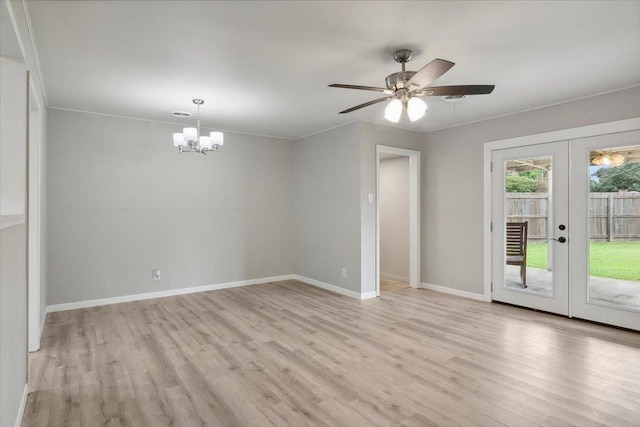 unfurnished room with ceiling fan with notable chandelier, light hardwood / wood-style floors, crown molding, and french doors