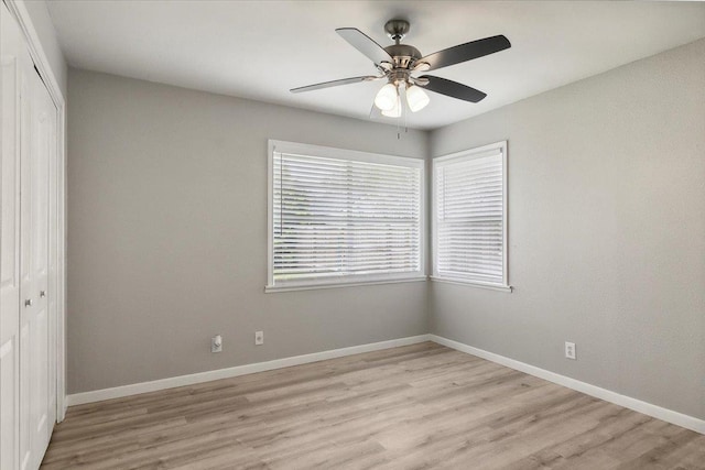 unfurnished bedroom featuring a closet, light hardwood / wood-style flooring, and ceiling fan