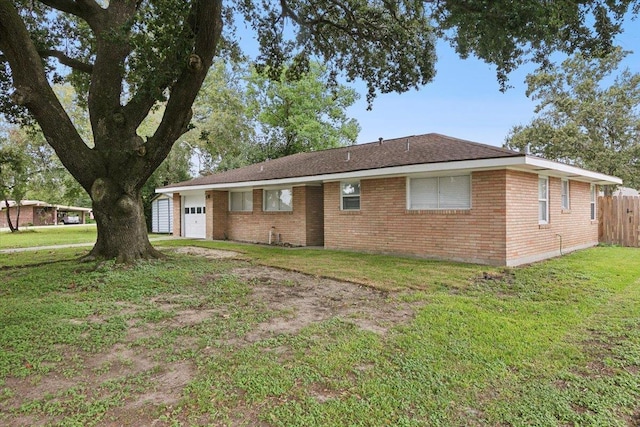 view of side of property featuring a lawn and a garage