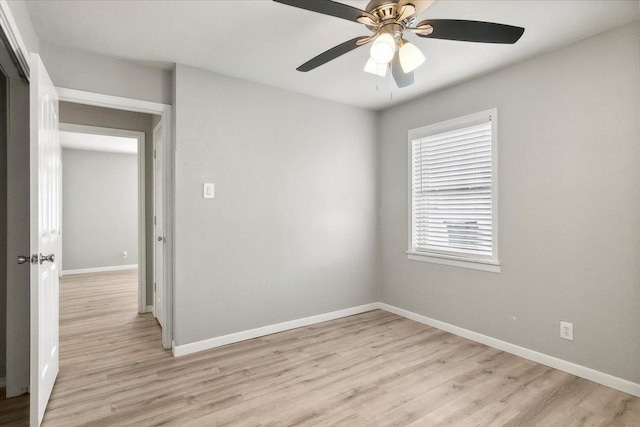 empty room featuring light wood-type flooring and ceiling fan