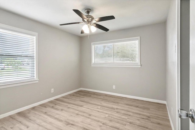 unfurnished room with light hardwood / wood-style floors, a wealth of natural light, and ceiling fan