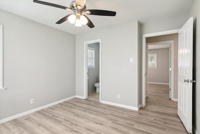 unfurnished bedroom with ceiling fan, connected bathroom, and light hardwood / wood-style flooring