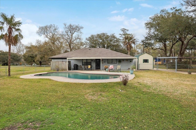 back of house with a fenced in pool, a lawn, a patio, and fence