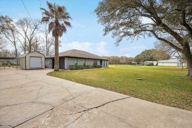 view of front facade featuring a carport, a garage, concrete driveway, and a front yard