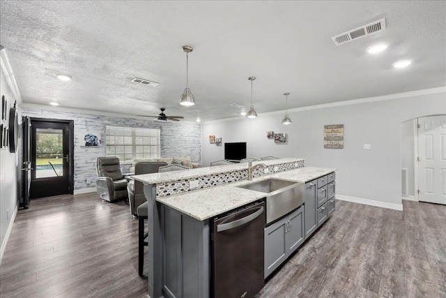 kitchen with dishwasher, gray cabinetry, visible vents, and a sink