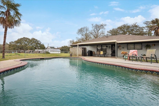 view of swimming pool featuring a fenced in pool, a patio, and fence