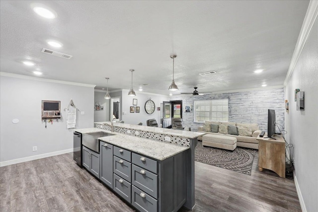 kitchen with visible vents, gray cabinetry, a sink, a textured ceiling, and dishwasher