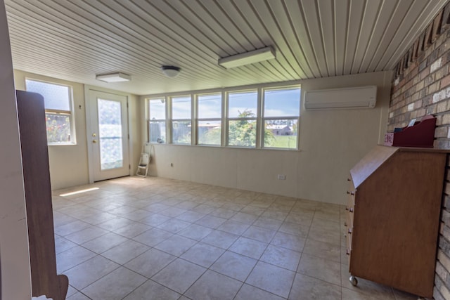 6470 Wilder Dr, Beaumont, TX 77706 - empty room with an AC wall unit, tile patterned floors, and healthy amount of natural light