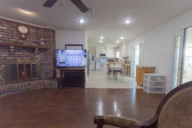 6470 Wilder Dr, Beaumont, TX 77706 - living area with ceiling fan, a brick fireplace, light wood-style flooring, and recessed lighting