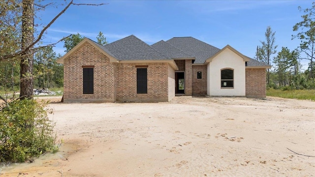 7170 Keith Rd, Lumberton, TX 77657 - view of front of house featuring brick siding and roof with shingles