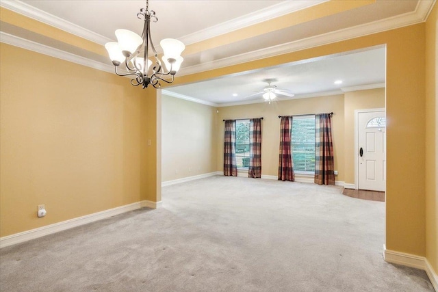 empty room featuring carpet flooring, ceiling fan with notable chandelier, and ornamental molding