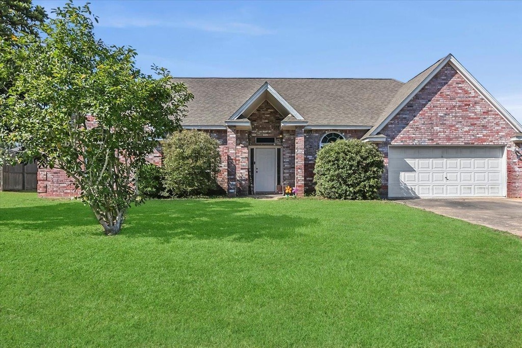 view of front facade with a front lawn and a garage