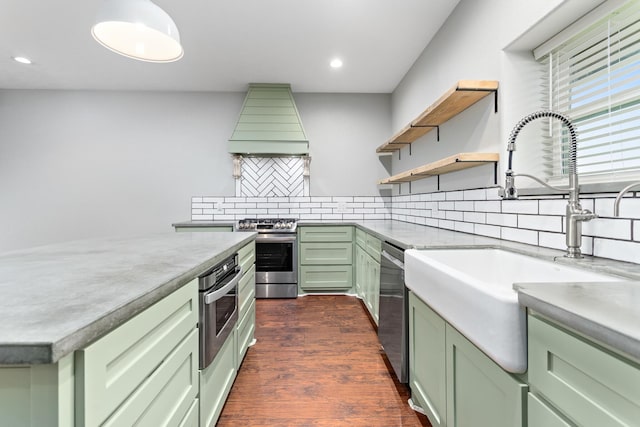 2050 Aggie Dr, Beaumont, TX 77713 - kitchen with green cabinets, stainless steel appliances, premium range hood, open shelves, and backsplash