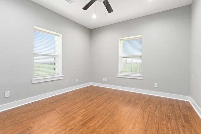 2050 Aggie Dr, Beaumont, TX 77713 - unfurnished room featuring baseboards, visible vents, wood finished floors, and ceiling fan