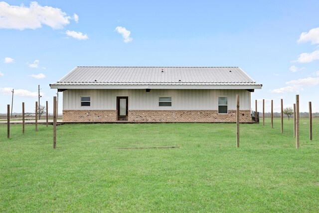 2050 Aggie Dr, Beaumont, TX 77713 - rear view of property with brick siding, metal roof, and a yard
