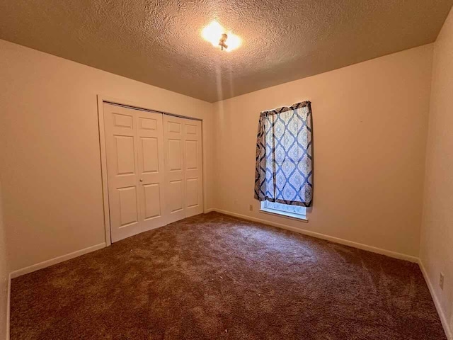 4220 Flamingo Ln, Beaumont, TX 77705 - unfurnished bedroom with carpet flooring, a textured ceiling, and a closet