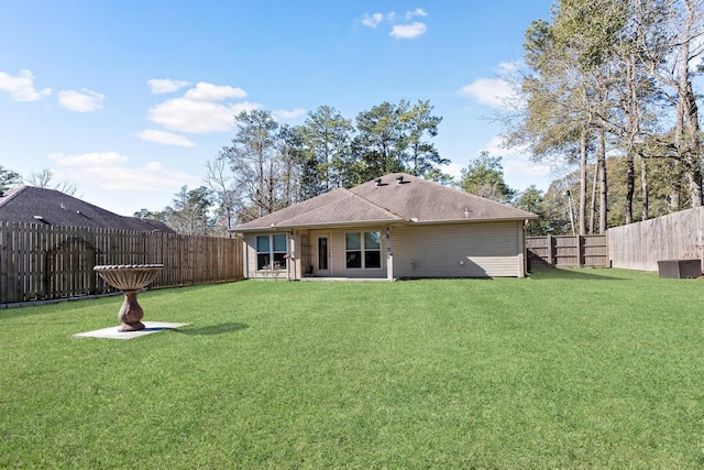 rear view of property featuring a yard