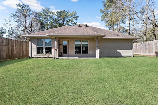 back of house with a lawn