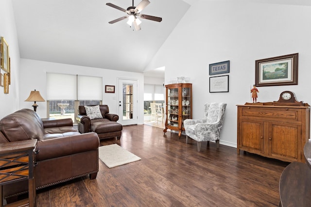 living room featuring high vaulted ceiling, plenty of natural light, dark wood-type flooring, and ceiling fan