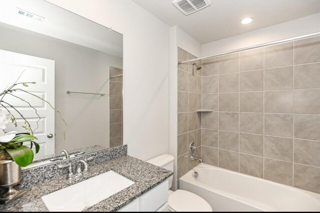 bathroom featuring shower / bath combination, visible vents, toilet, and vanity