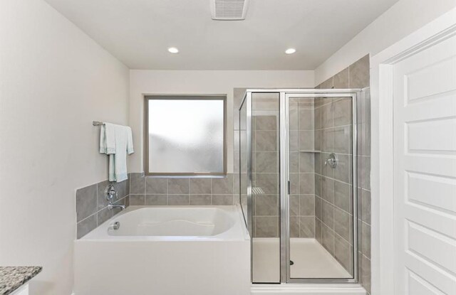full bath with recessed lighting, a stall shower, a garden tub, and visible vents