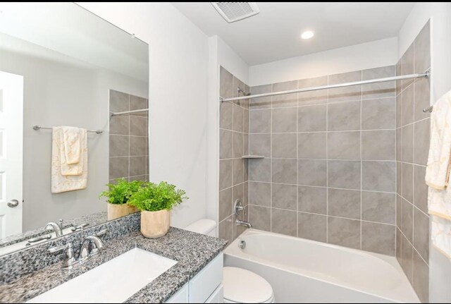 bathroom featuring toilet, vanity, shower / bathtub combination, visible vents, and recessed lighting