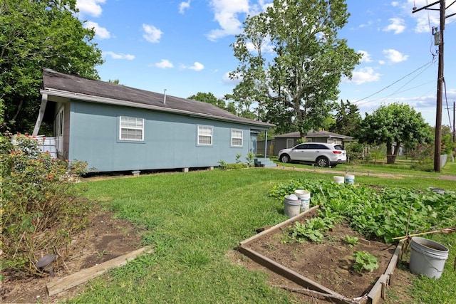 2850 S Major Dr, Beaumont, TX 77707 - view of home's exterior with a yard and a vegetable garden
