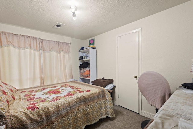 2850 S Major Dr, Beaumont, TX 77707 - carpeted bedroom featuring a textured ceiling