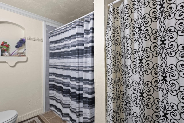 2850 S Major Dr, Beaumont, TX 77707 - bathroom featuring ornamental molding, tile patterned flooring, a textured ceiling, and a shower with curtain