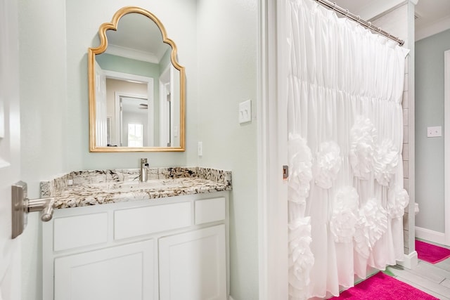 bathroom with vanity and ornamental molding