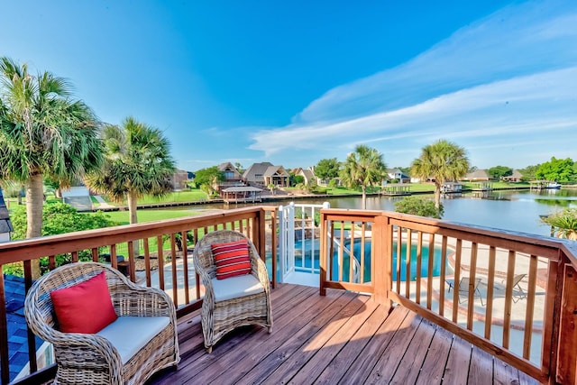 wooden terrace with a water view and a pool