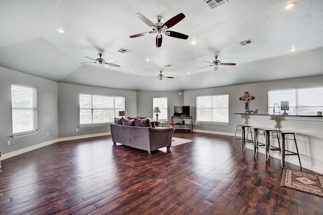 living room featuring dark hardwood / wood-style flooring and vaulted ceiling