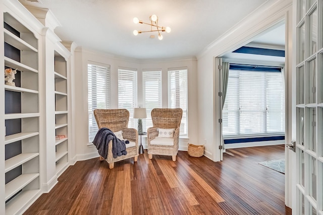 living area with dark wood-type flooring, plenty of natural light, a chandelier, and ornamental molding