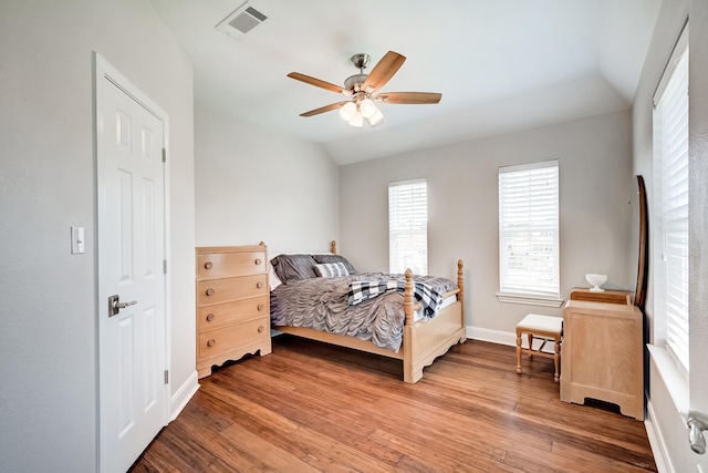 bedroom featuring ceiling fan, hardwood / wood-style floors, and vaulted ceiling