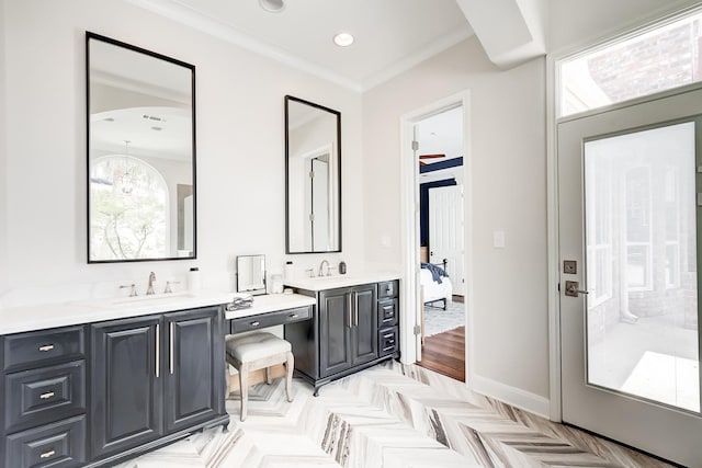 bathroom featuring crown molding, vanity, and parquet flooring