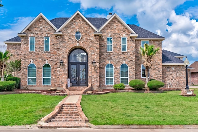 view of front of home featuring a front yard and french doors