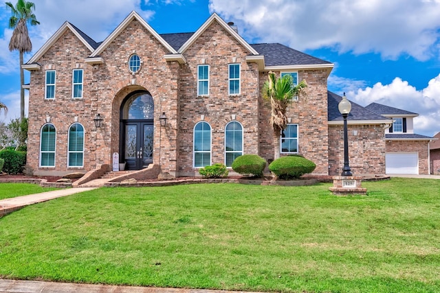 view of front of home with french doors and a front lawn