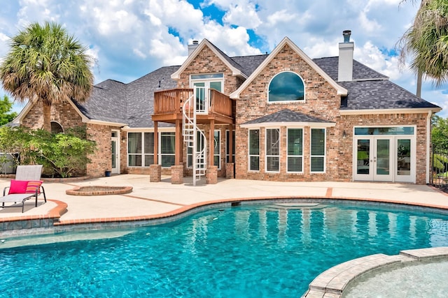 view of swimming pool featuring a patio area and french doors