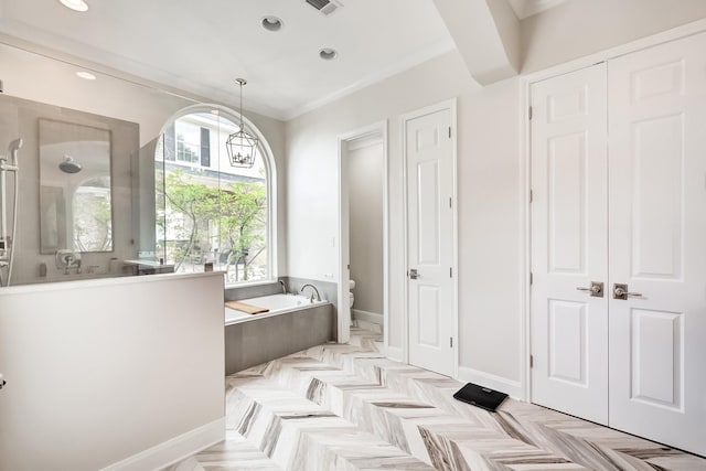 bathroom featuring crown molding, toilet, a chandelier, and walk in shower