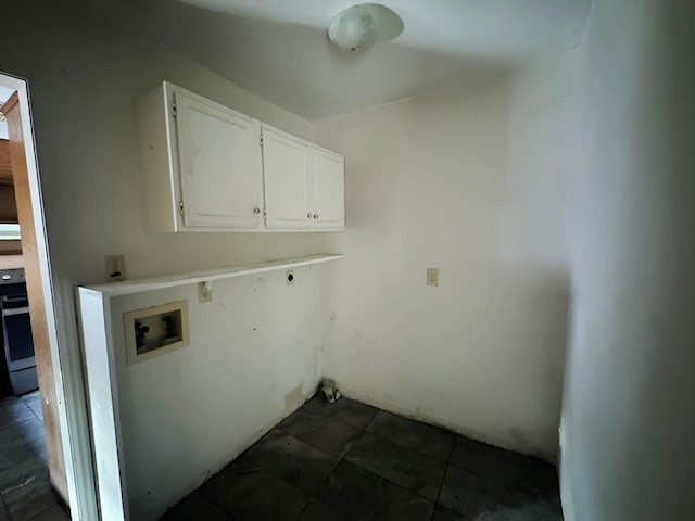 849 Dillon Dr, Silsbee, TX 77656 - laundry area with cabinet space, hookup for a washing machine, and dark tile patterned floors