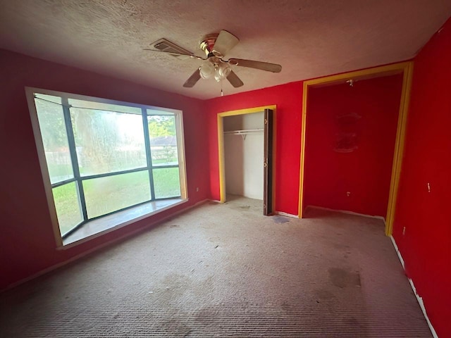 849 Dillon Dr, Silsbee, TX 77656 - unfurnished bedroom with carpet flooring, multiple closets, and a ceiling fan