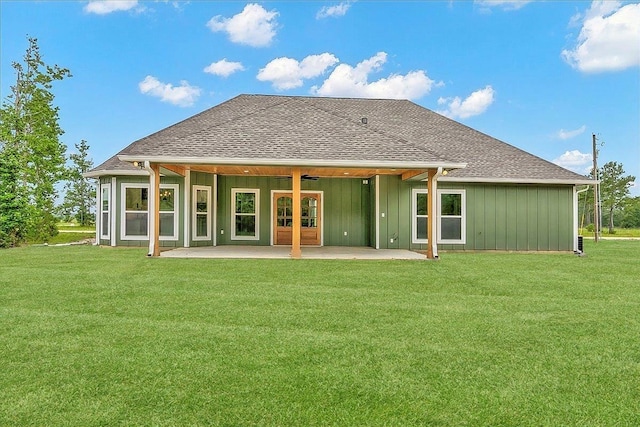 back of property with a yard and a patio area